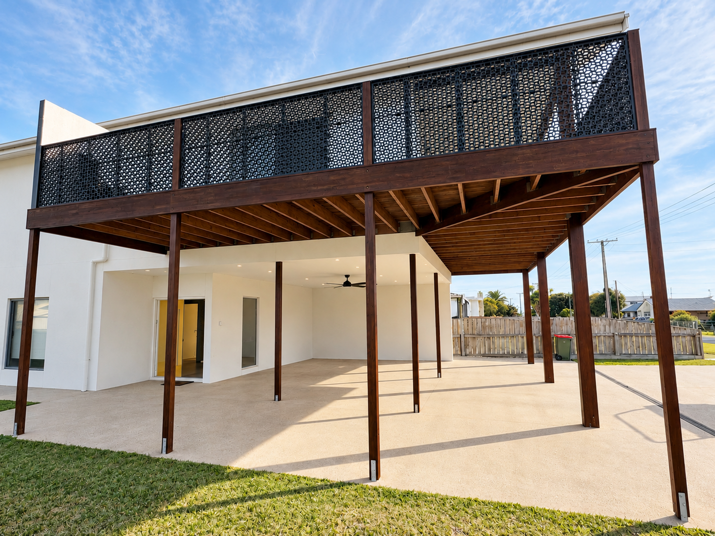 Two-storey new build with timber decking and decorative laser-cut screening